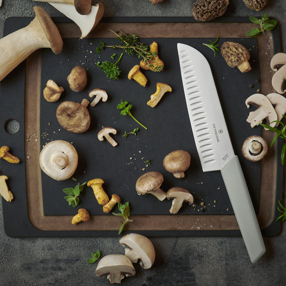 Swiss Modern Colors 7.5" Granton Edge Santoku Knife in Olive Green by Victorinox on Cutting Board