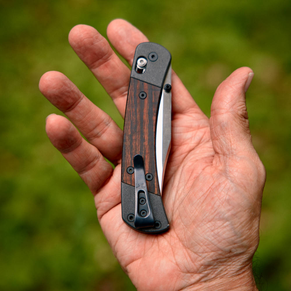 Buck 110 Folding Hunter Crossbar Knife in Hand Back View, Closed with Pocket Clip