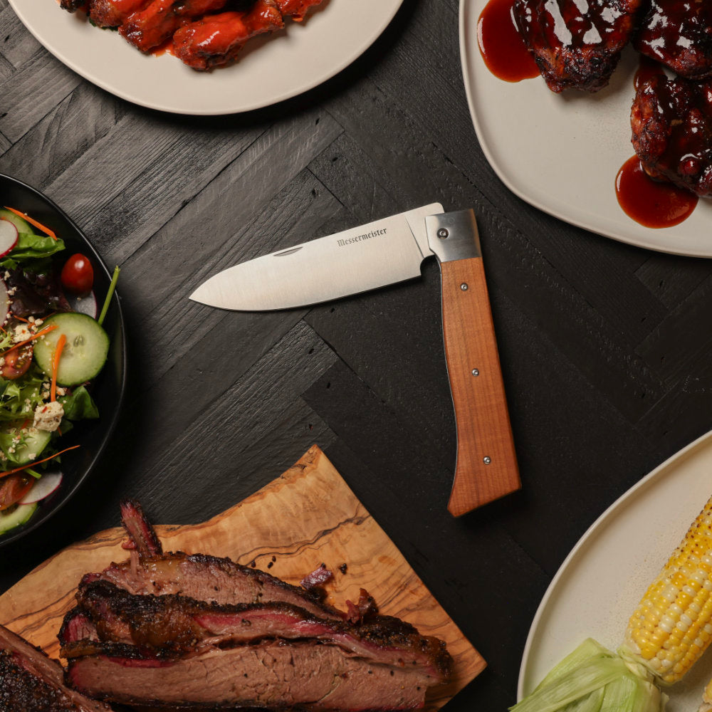 Messermeister Adventure Chef 6-inch Folding Chef's Knife in Use with BBQ Food