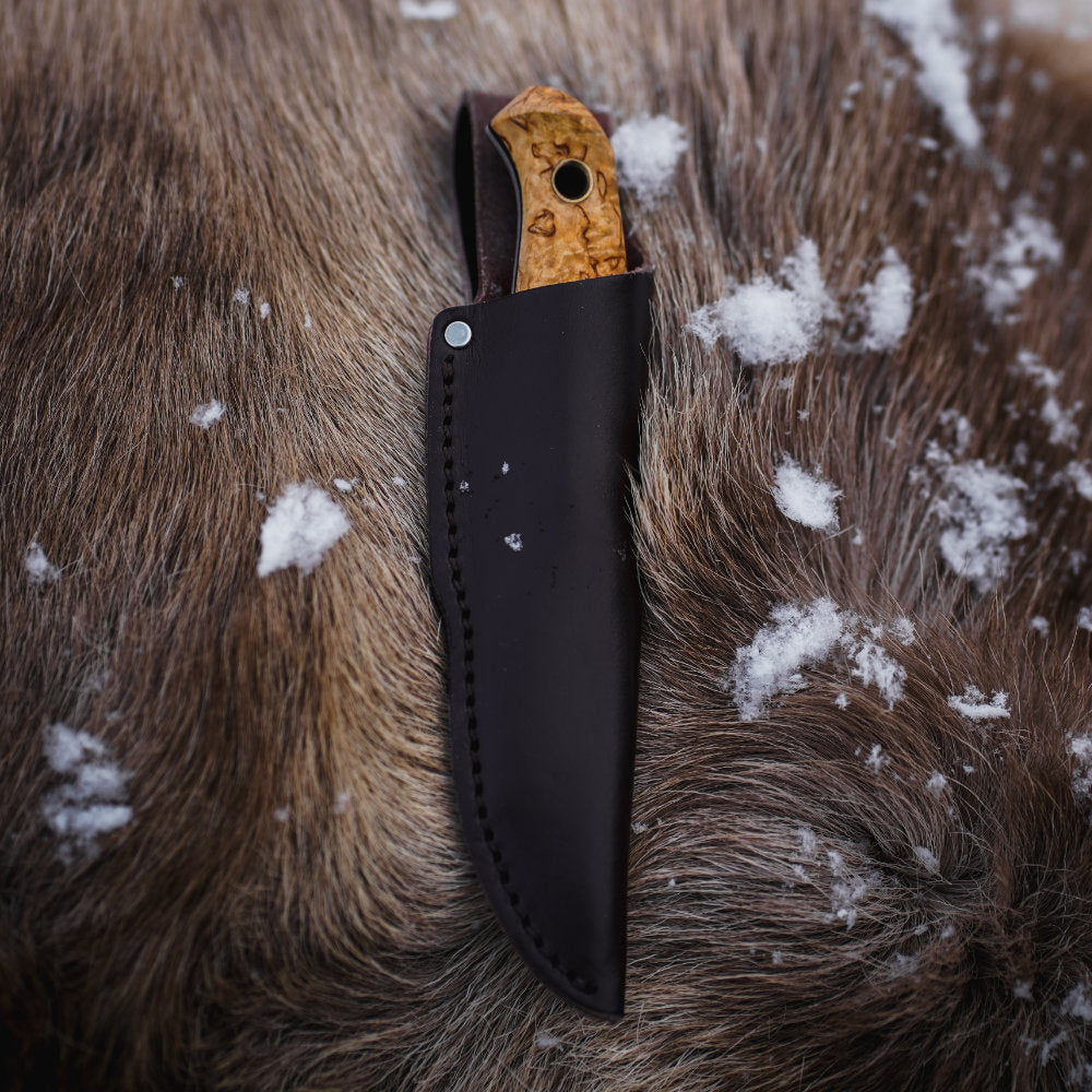 Helle Polaris Compact Outdoor Knife in Sheath on Hide with Snow