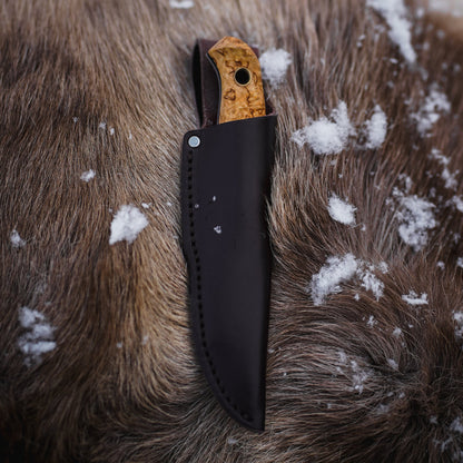 Helle Polaris Compact Outdoor Knife in Sheath on Hide with Snow