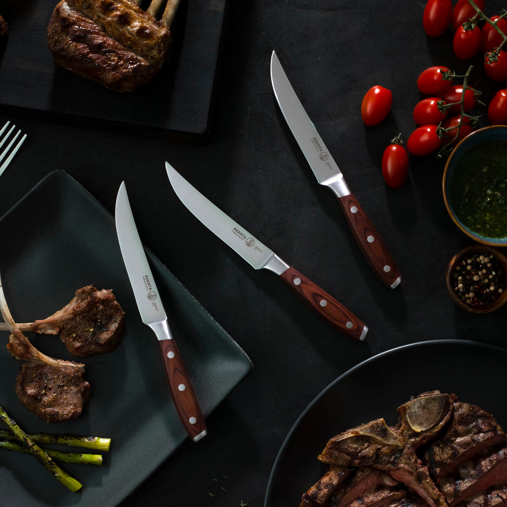 Messermeister Avanta Forged 4-Piece Steak Knife Set on Table with Lamb and Steak
