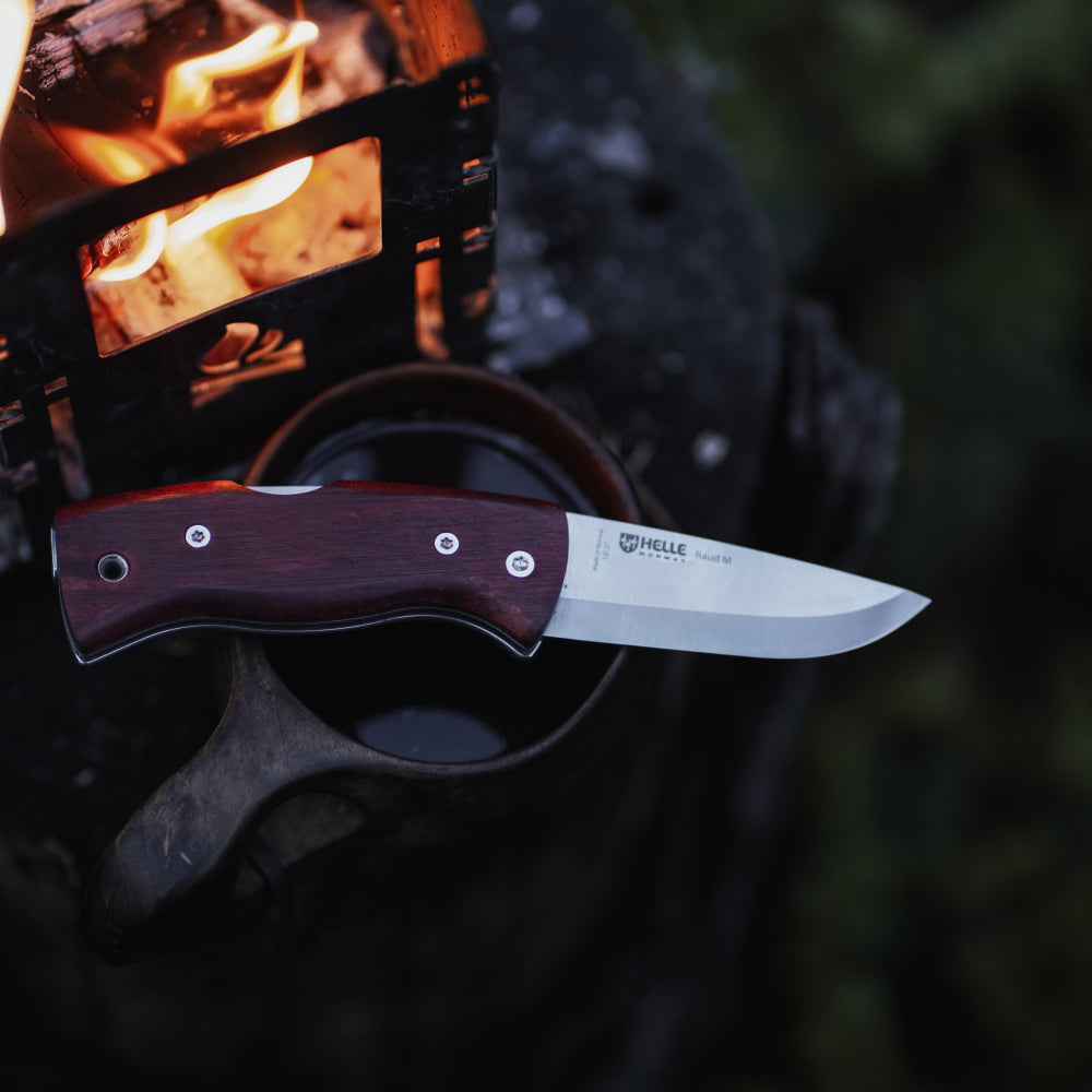 Helle Raud M Folding Outdoor Knife in Use by the Campfire