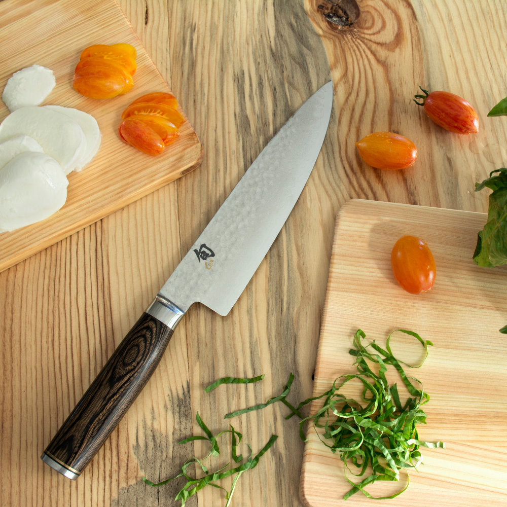 https://www.swissknifeshop.com/cdn/shop/files/SKTDM0706-Shun-Premier-Chef-Knife-Chopping-Vegetables.jpg?v=1685542614&width=1946