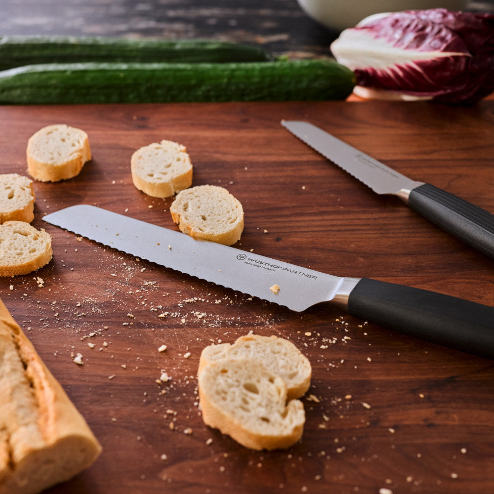 Wusthof Partner 8" Bread Knife Cutting a Crusty Baguette