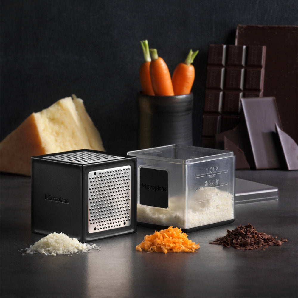 https://www.swissknifeshop.com/cdn/shop/products/MP34002-Microplane-Cube-Grater-Black-with-Grated-Foods.jpg?v=1676494510&width=1946